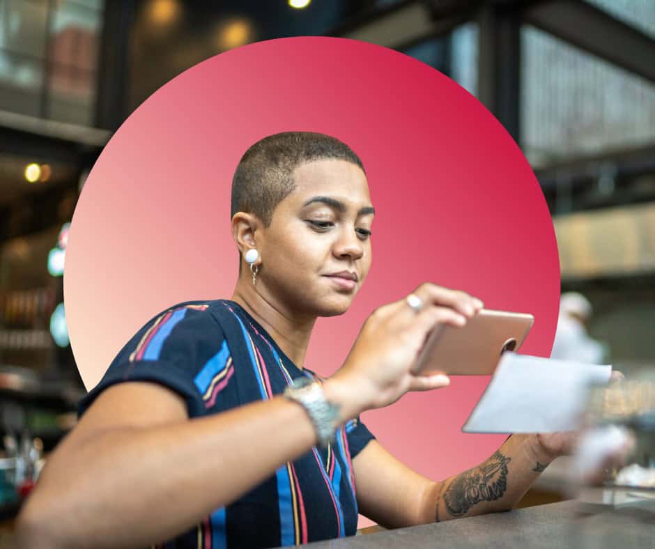 A young woman uses her banking mobile app to deposite a check.