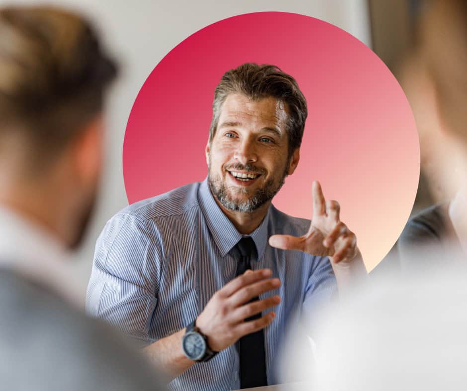 A smartly dressed man expresses excitement in an office setting