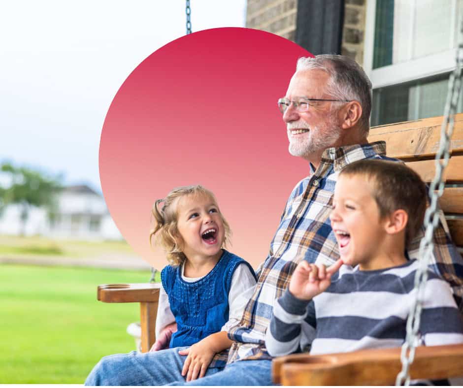 A granddad sits on his front porch swing with his grandchildren.